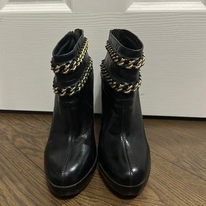 Used Tory Burch Lysa black leather ankle boots with gold chain detail. Size 7.5.